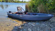 Load image into Gallery viewer, FluxJet electric fishing kayak with seat and gear by lake shore

