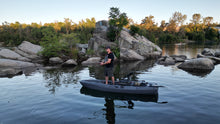 Load image into Gallery viewer, Man fishing from FluxJet electric kayak on calm rocky lake
