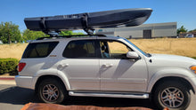 Load image into Gallery viewer, FluxJet electric kayak mounted on SUV roof rack for transport
